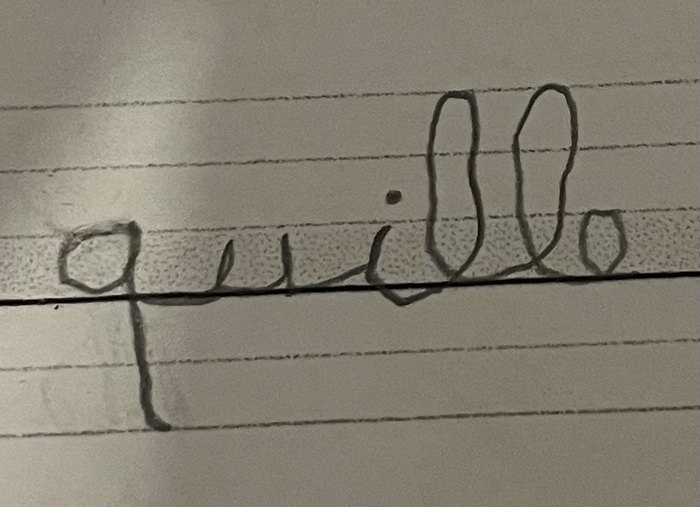 Le mot « quille » écrit avec de grandes lettres irrégulières et espacées.